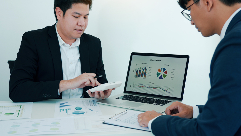 teamwork with business people analysis cost graph on desk at mee