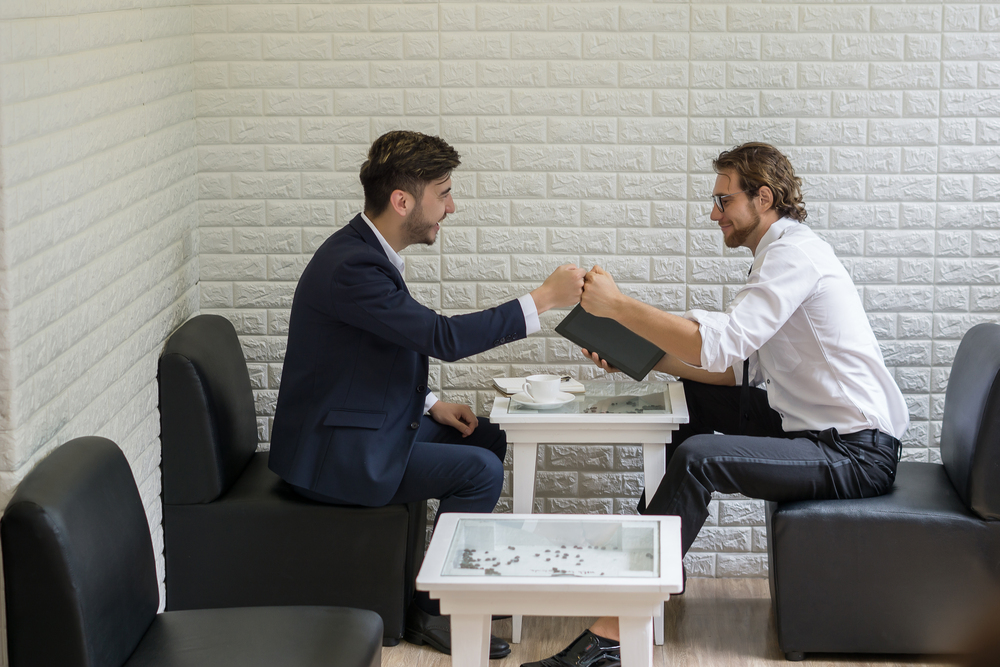 young businessman talking work with colleague in a modern busine