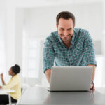 a man seated at a table using a laptop computer 2025 04 04 08 31 53 utc